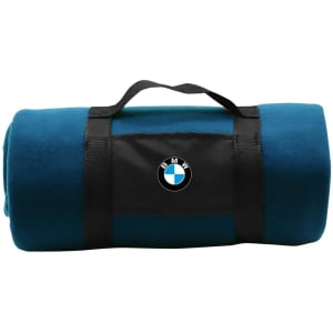 A teal blanket rolled and secured with a black strap featuring a logo. Ideal for home or outdoor use.