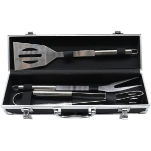 A stainless steel BBQ tool set including a spatula, fork, and tongs, housed in a black deluxe case with a handle.