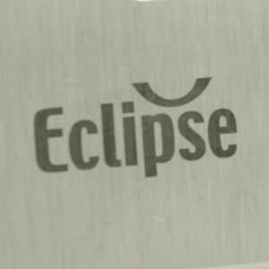 A close-up of a metallic surface featuring the word "Eclipse" in a modern font. The background is brushed aluminium.