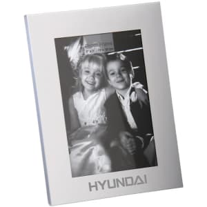 A classic aluminium photo frame in silver, featuring a black and white photo of two children. Includes a logo.