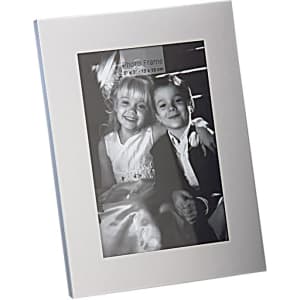 A classic aluminium photo frame in silver, featuring a portrait orientation and an image of two children.