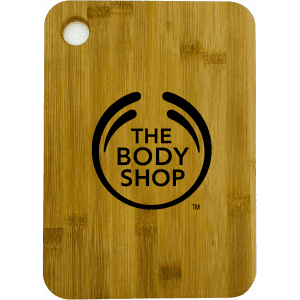 A large bamboo cutting board with rounded corners, featuring a logo on the surface.