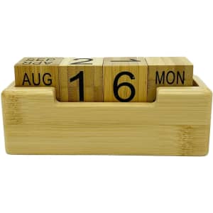A bamboo perpetual calendar featuring cubed date and month blocks in a natural wood holder.