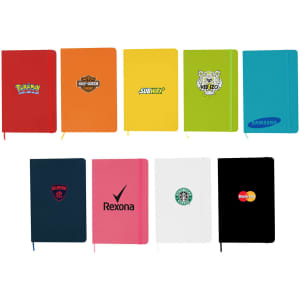 A collection of colourful A5 notebooks in various shades, featuring different logos and branding on the covers.