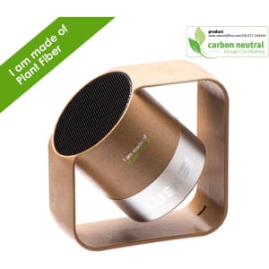 A wireless speaker with a cylindrical design in natural wood tones and a square base, featuring a logo.