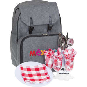 A grey picnic backpack with cutlery, plates, and checkered napkins displayed in front. The backpack features a logo.