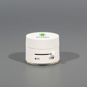 A white suction phone stand with an adjustable switch and an Android logo on top, set against a grey background.
