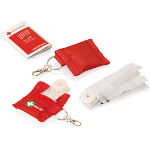 A red first aid CPR mask keyring with a transparent pocket, containing a CPR mask and instructions.