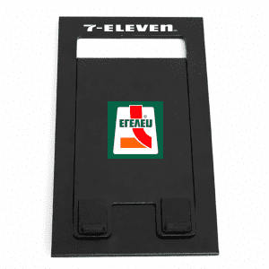 A black foldable phone stand featuring a logo on the front. The design is sleek and minimalist.