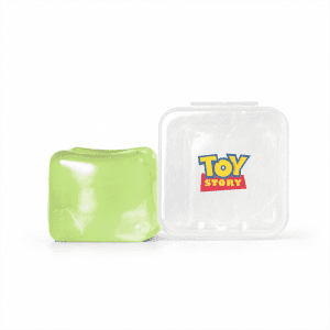 A green jelly cube sensory toy next to a clear container featuring a logo.