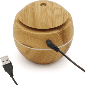 A round, wooden diffuser with a smooth, natural finish and a USB cable. It features a lid on top.