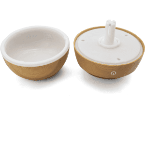 A wooden-textured diffuser with a white ceramic interior, featuring a base with a central nozzle and a logo.