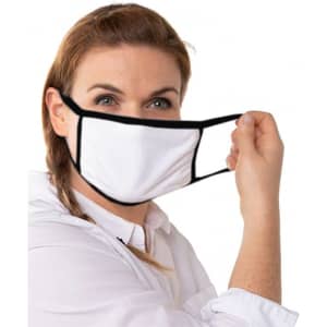 A woman holding a white cotton face mask with black edges. The mask has ear loops for wear.