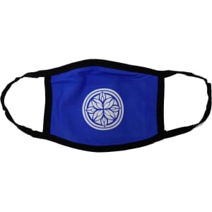 A cotton face mask in blue with a black trim and a circular logo design in the centre.
