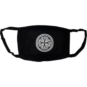 A black cotton face mask featuring a circular geometric design in the centre and ear straps for secure fitting.