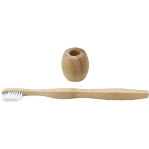 A bamboo toothbrush with a white bristle head and a matching bamboo holder.