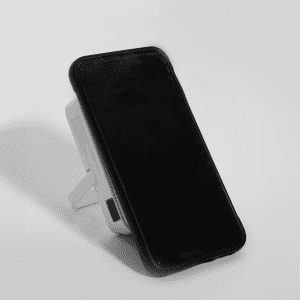 A wireless charging power bank in white, featuring a stand and a black face. It has a logo on the side.