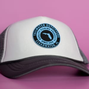 A cap featuring a white front and grey mesh back, with a circular logo at the front.