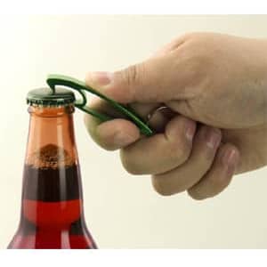 A drink bottle opener in green being used to remove a cap from a glass bottle with a vibrant liquid inside.