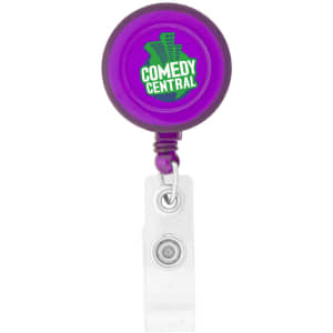A round badge holder in purple with a clear clip and a logo on the front.