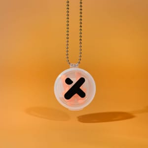 A silicone earplug keychain in a clear case with a black logo, featuring an orange earplug set, suspended by a metal chain.