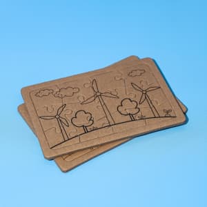 A jigsaw puzzle set featuring two puzzles with wind turbines and trees, made of brown cardboard.