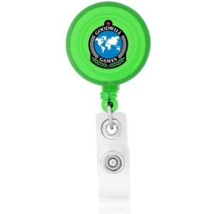 A green round badge holder with a retractable cord and a clear attachment clip, featuring a logo on its front.