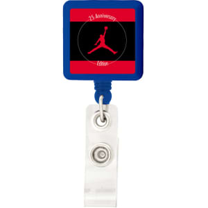 A blue rectangle badge holder with a clear clip and a logo in the centre featuring a red and black design.