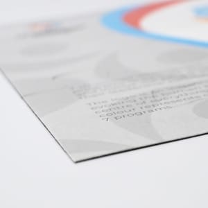 A magnetic jigsaw puzzle, featuring a colourful design with blue, red, and grey elements, showcasing a logo.