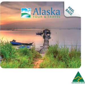 A mouse mat featuring a scenic image of a pier at sunset, with greenery and boats, showcasing blue and earthy tones.