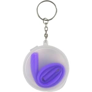 A purple reusable silicone straw coiled inside a clear case with a keychain attachment.