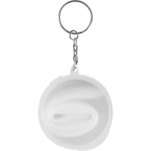 A round keychain with a silver ring and a white silicone straw coiled inside a transparent case.