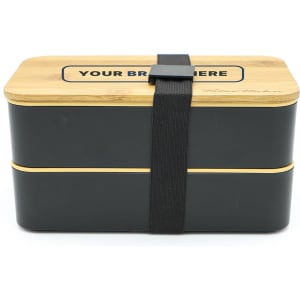 A two-layer lunch box with a dark exterior and a bamboo lid, secured with a black strap. Features a logo.