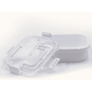 A white lunch box with a transparent lid, featuring clips for secure closure.