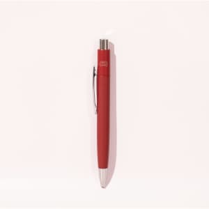 A red metal pen featuring a sleek design and a clip, with a logo on its barrel.