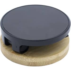 A round black magnetic phone holder sits atop a circular bamboo base. It features a simple and modern design.