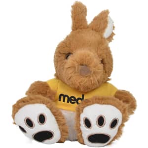 A plush kangaroo toy in brown with white paws, wearing a yellow shirt and featuring a logo on it.