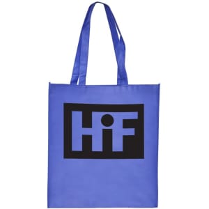 A large blue shopping tote bag with a black logo on the front and long straps for carrying.