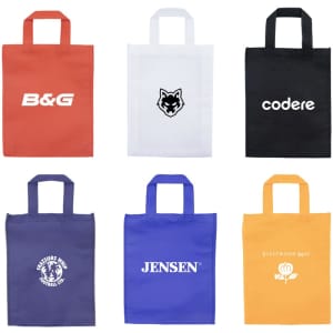 A collection of six tote bags in orange, white, black, purple, blue, and yellow, each with a logo.