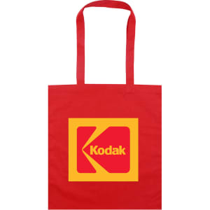 A red tote bag featuring a large yellow square with a logo, including a prominent 'K' design.
