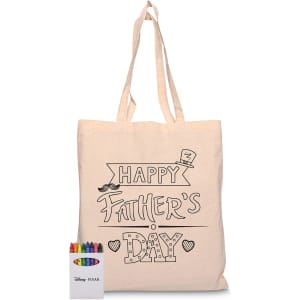 A beige tote bag featuring a black design for Father's Day, alongside a box of coloured crayons.