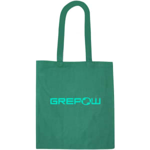 A green recycled cotton tote bag featuring a logo on the front. The bag has two sturdy handles.