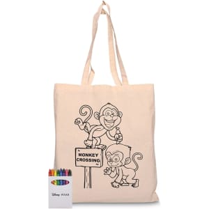 A beige calico bag featuring a monkey design, accompanied by a set of crayons in various colours.