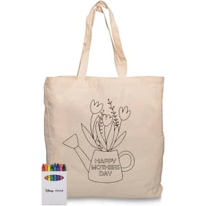 A cream tote bag featuring a floral watering can design and a crayon set in various colours.