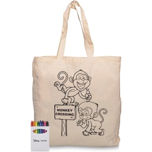 A cream-coloured calico bag featuring monkey designs and a set of crayons in various colours beside it.