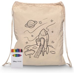 A cream drawstring bag featuring a rocket ship design, accompanied by a crayon set in various colours.