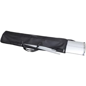 A black carry bag containing a silver roll-up banner and metal poles, all neatly bundled for transport.