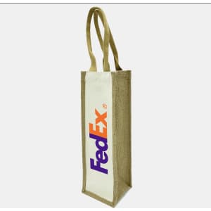 A jute wine bag in natural brown with a white panel and a distinctive logo. It features two sturdy handles.