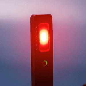 A rechargeable work light with a red light and a green indicator, featuring a sleek black design and a logo.