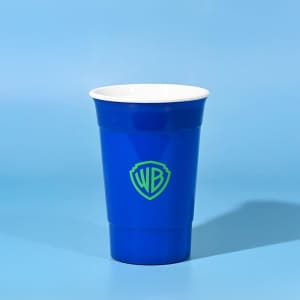 A blue double wall party cup with a white interior, featuring a logo on the front.